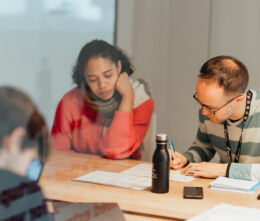 Group of students discussing a project at a startup office table